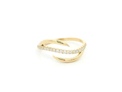 18K yellow gold diamond crossover ring featuring a flowing twist design set with 0.21 carat natural diamonds.