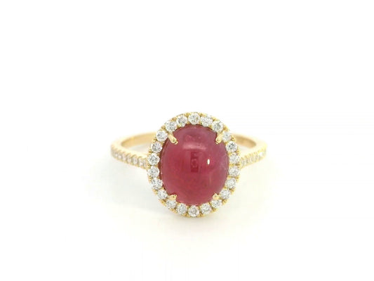 18K yellow gold ruby cabochon halo ring featuring a 4.17 carat natural oval ruby surrounded by 0.33 carat natural diamonds.