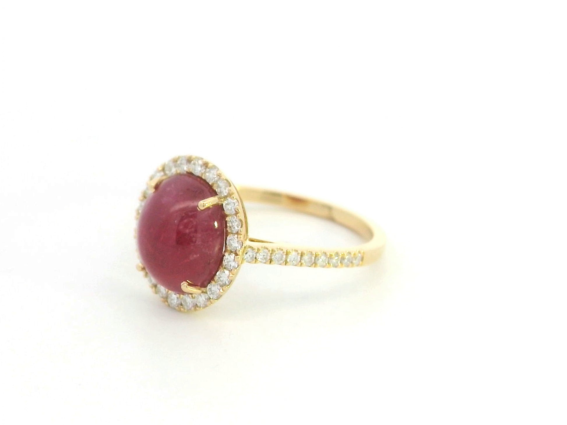 18K yellow gold ruby cabochon halo ring featuring a 4.17 carat natural oval ruby surrounded by 0.33 carat natural diamonds.