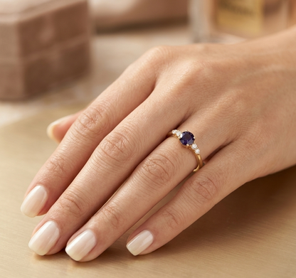 Natural Blue Sapphire and Diamond Ring in 18K Yellow Gold featuring a 0.65 carat round blue sapphire with 0.25 carat natural diamond side stones.