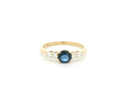 Natural Blue Sapphire and Diamond Ring in 18K Yellow Gold featuring a 0.65 carat round blue sapphire with 0.25 carat natural diamond side stones.
