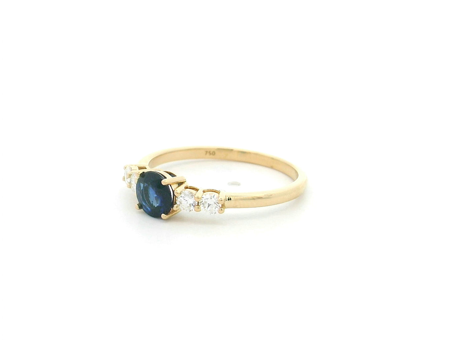 Natural Blue Sapphire and Diamond Ring in 18K Yellow Gold featuring a 0.65 carat round blue sapphire with 0.25 carat natural diamond side stones.
