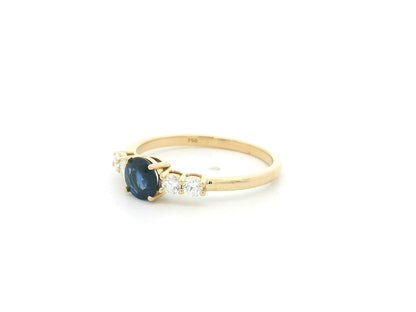 Natural Blue Sapphire and Diamond Ring in 18K Yellow Gold featuring a 0.65 carat round blue sapphire with 0.25 carat natural diamond side stones.