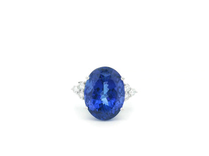Natural 14.12 carat oval tanzanite and diamond ring in 18K white gold with natural diamond shoulders.