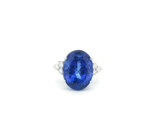Natural 14.12 carat oval tanzanite and diamond ring in 18K white gold with natural diamond shoulders.