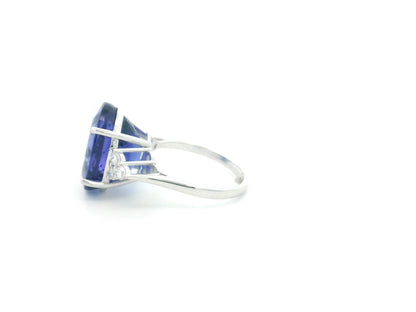 Natural 14.12 carat oval tanzanite and diamond ring in 18K white gold with natural diamond shoulders.