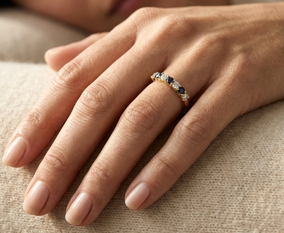 18K yellow gold half eternity ring featuring alternating natural blue sapphires and natural diamonds in a classic prong setting.