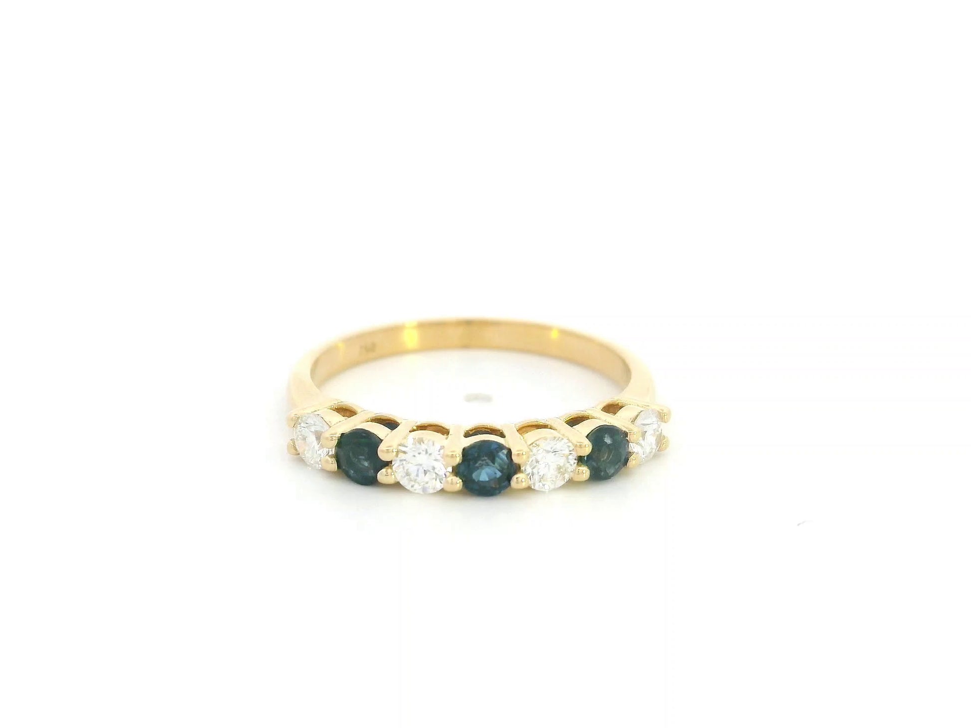 18K yellow gold half eternity ring featuring alternating natural blue sapphires and natural diamonds in a classic prong setting.