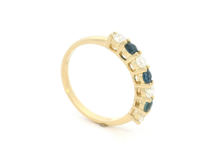 18K yellow gold half eternity ring featuring alternating natural blue sapphires and natural diamonds in a classic prong setting.