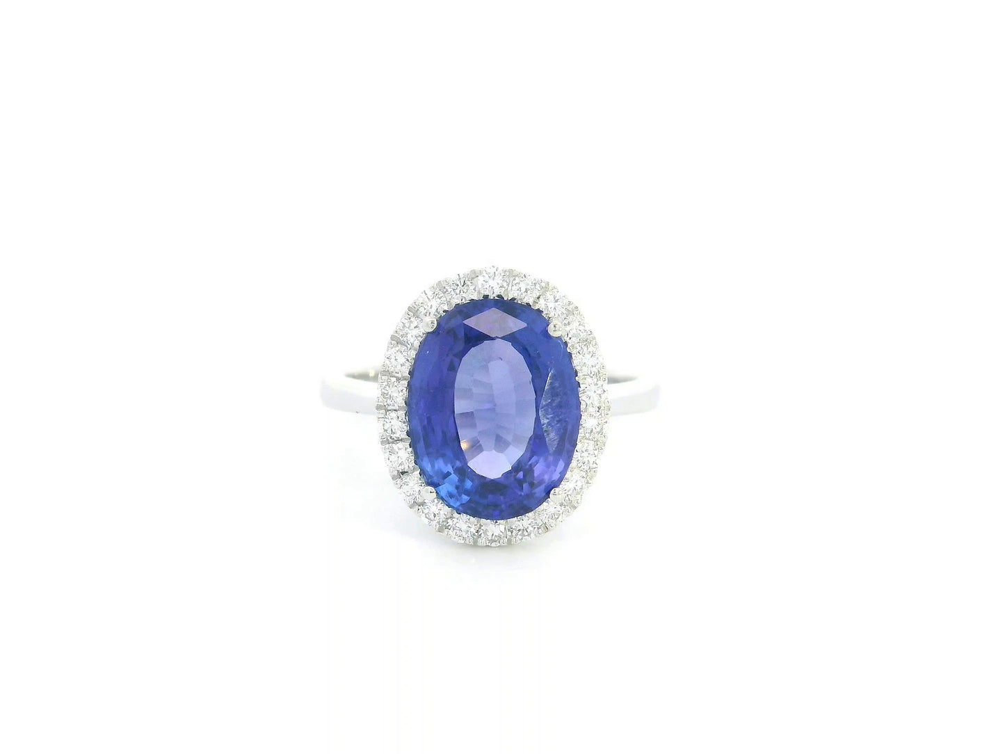 18K white gold halo ring featuring a 4.95 carat oval tanzanite surrounded by 0.37 carat natural diamonds.