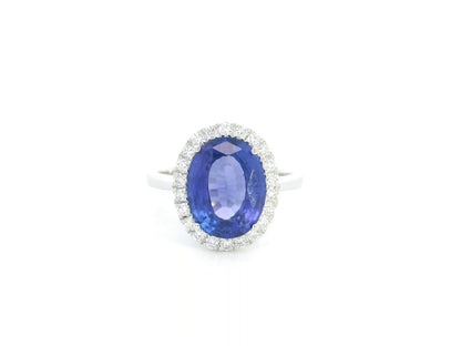 18K white gold halo ring featuring a 4.95 carat oval tanzanite surrounded by 0.37 carat natural diamonds.