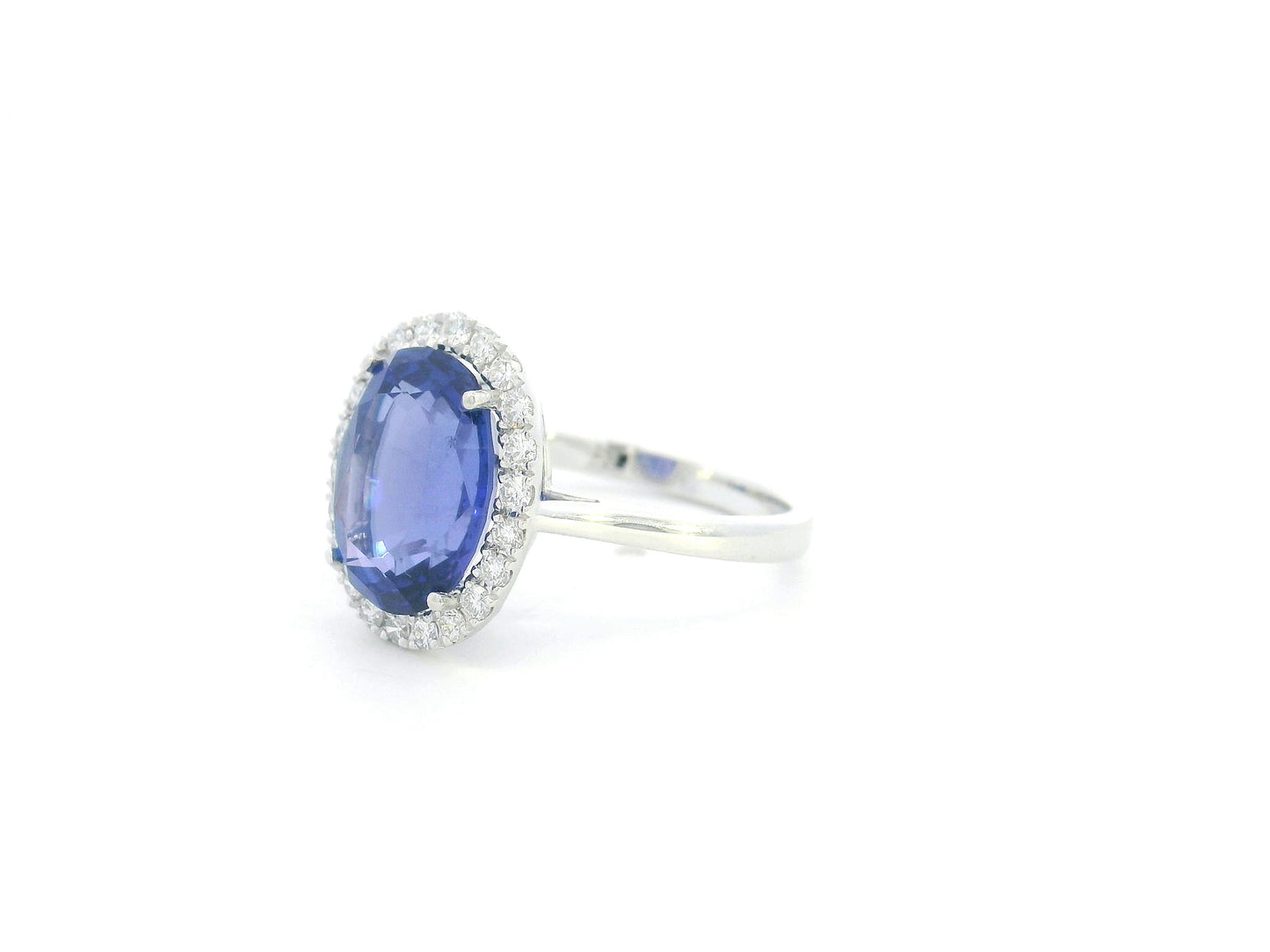 18K white gold halo ring featuring a 4.95 carat oval tanzanite surrounded by 0.37 carat natural diamonds.