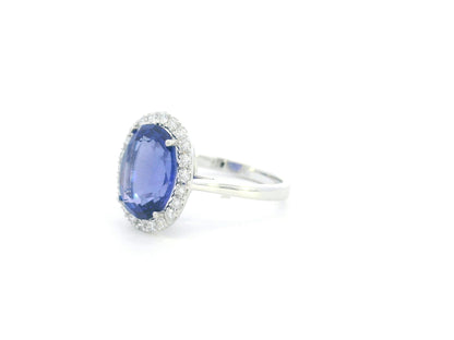 18K white gold halo ring featuring a 4.95 carat oval tanzanite surrounded by 0.37 carat natural diamonds.