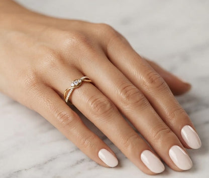 Natural diamond infinity ring in solid 18K yellow gold featuring 0.28 carat round brilliant diamonds in an elegant flowing infinity design.