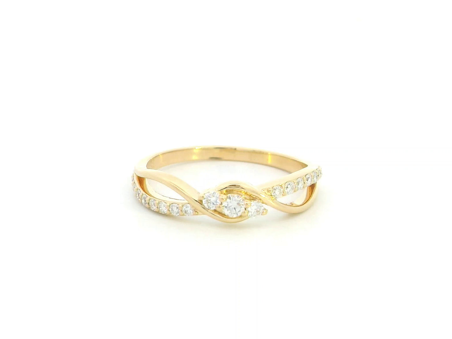 Natural diamond infinity ring in solid 18K yellow gold featuring 0.28 carat round brilliant diamonds in an elegant flowing infinity design.