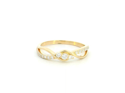 Natural diamond infinity ring in solid 18K yellow gold featuring 0.28 carat round brilliant diamonds in an elegant flowing infinity design.