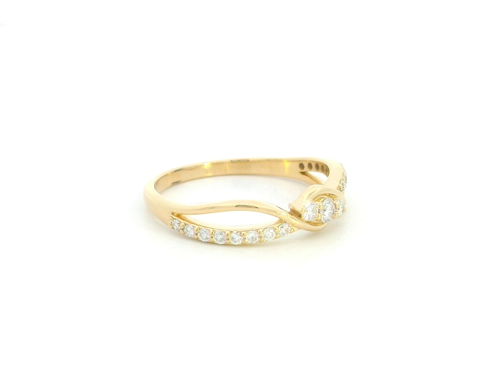 Natural diamond infinity ring in solid 18K yellow gold featuring 0.28 carat round brilliant diamonds in an elegant flowing infinity design.