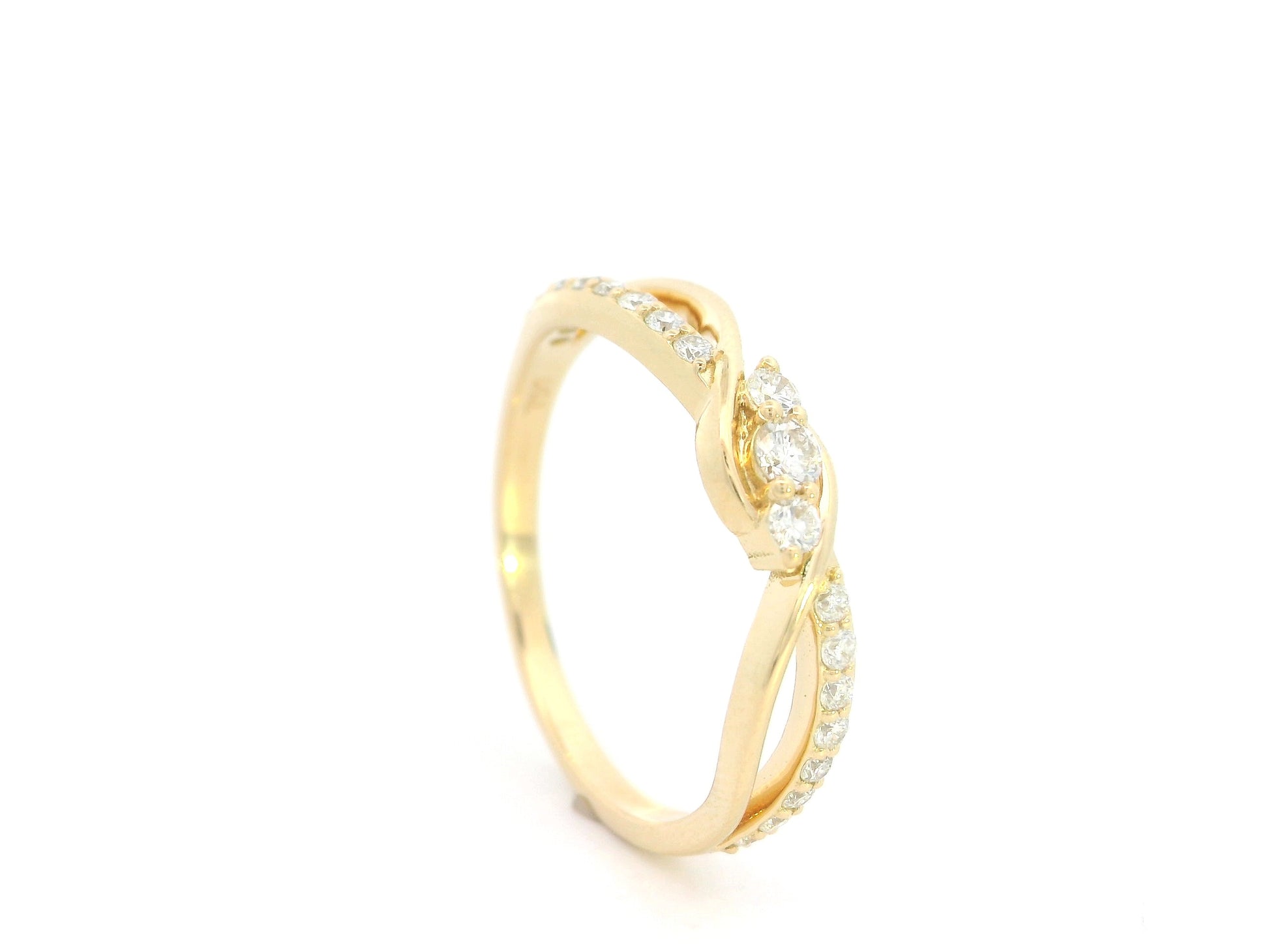 Natural diamond infinity ring in solid 18K yellow gold featuring 0.28 carat round brilliant diamonds in an elegant flowing infinity design.