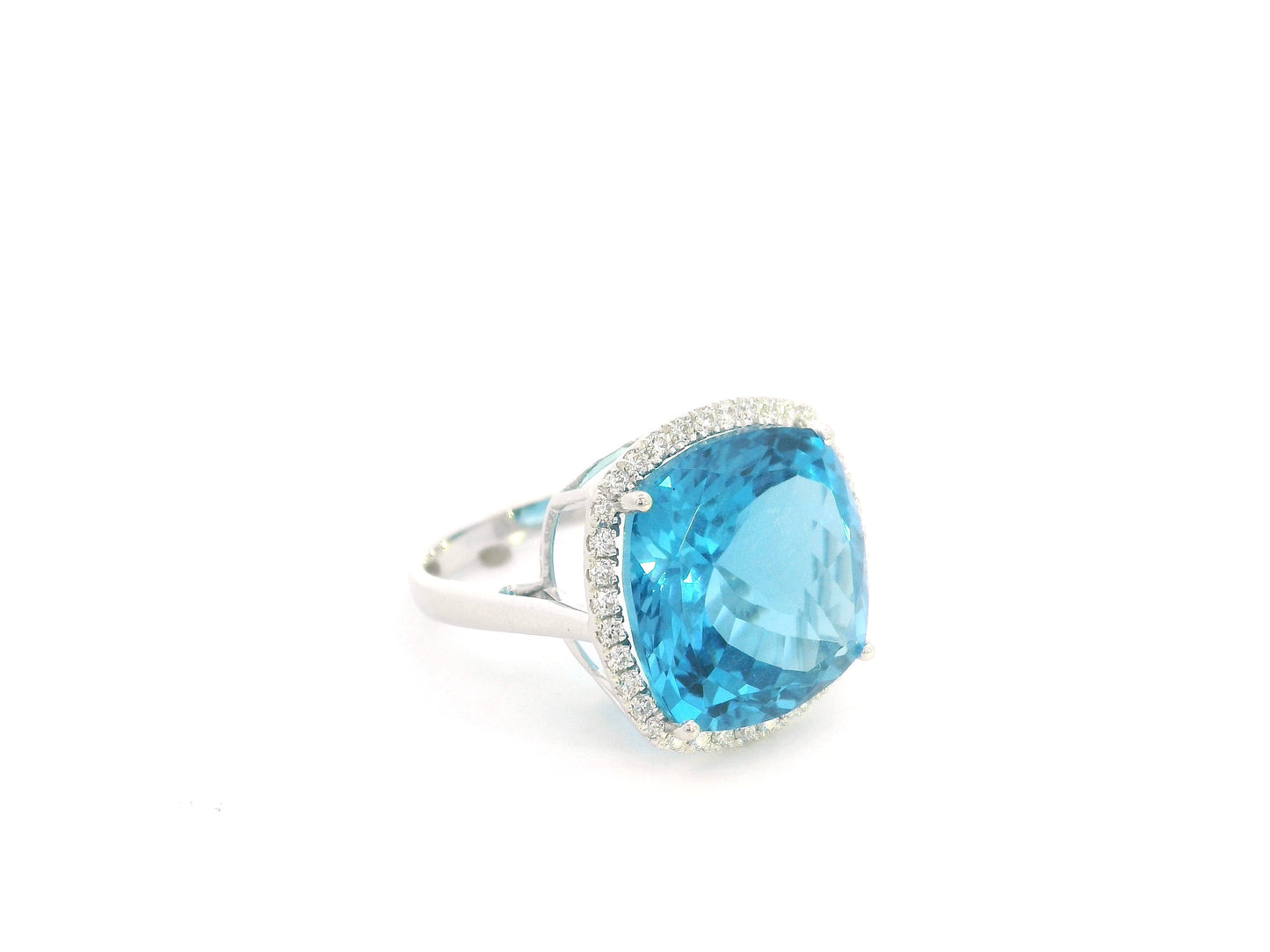 18K white gold cushion cut blue topaz halo ring featuring an 18.55 carat natural blue topaz surrounded by 0.37 carat natural diamonds.