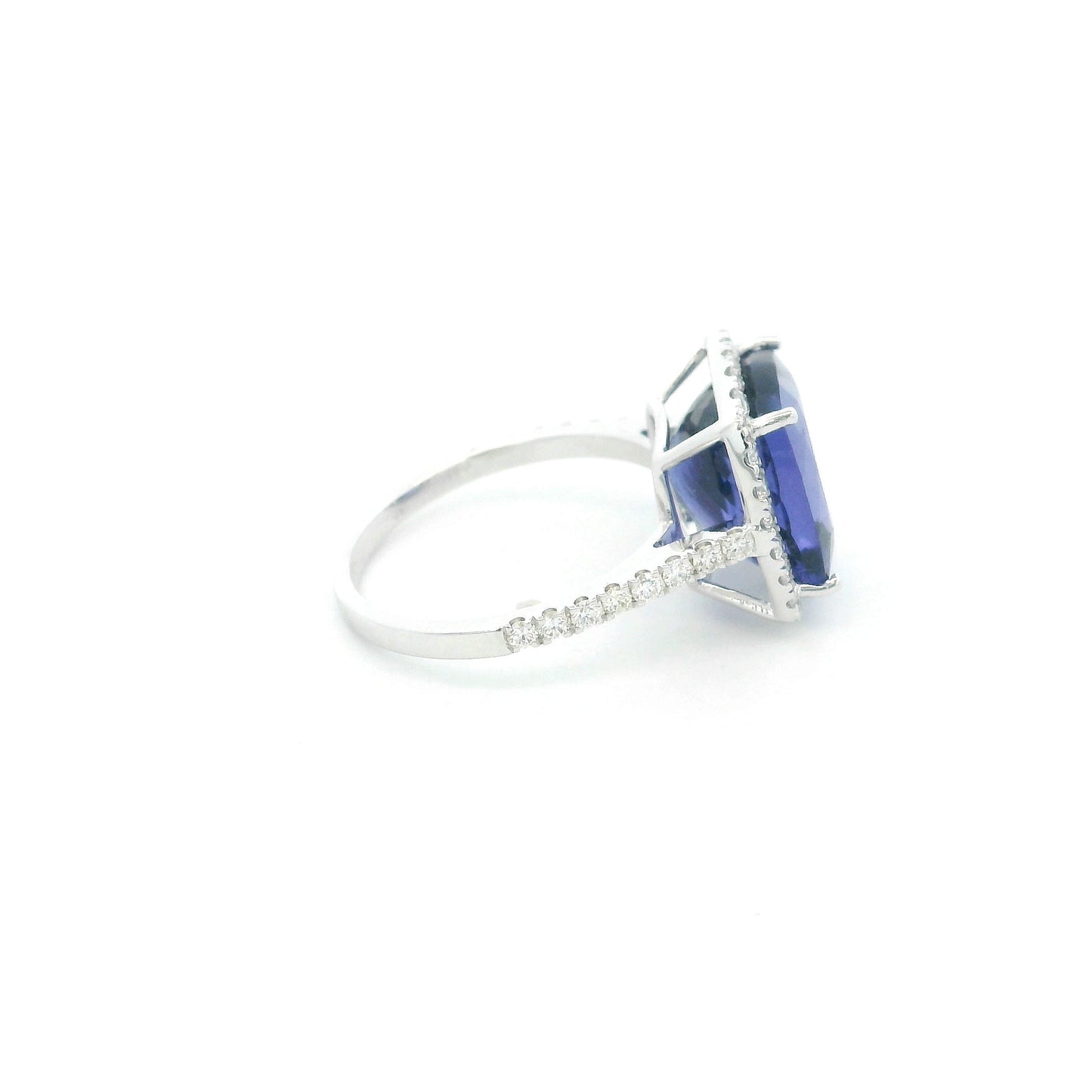 18K white gold cushion cut tanzanite halo ring featuring an 8.95 carat natural tanzanite surrounded by 0.69 carat natural diamonds with diamond-set shoulders.