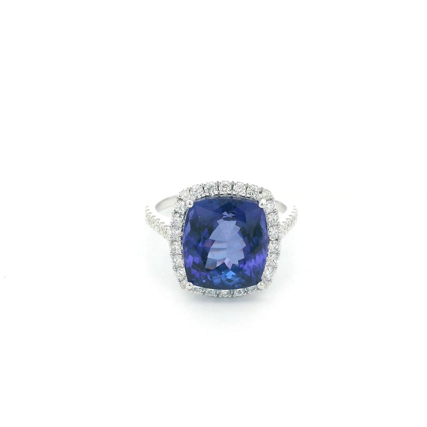 18K white gold cushion cut tanzanite halo ring featuring an 8.95 carat natural tanzanite surrounded by 0.69 carat natural diamonds with diamond-set shoulders.
