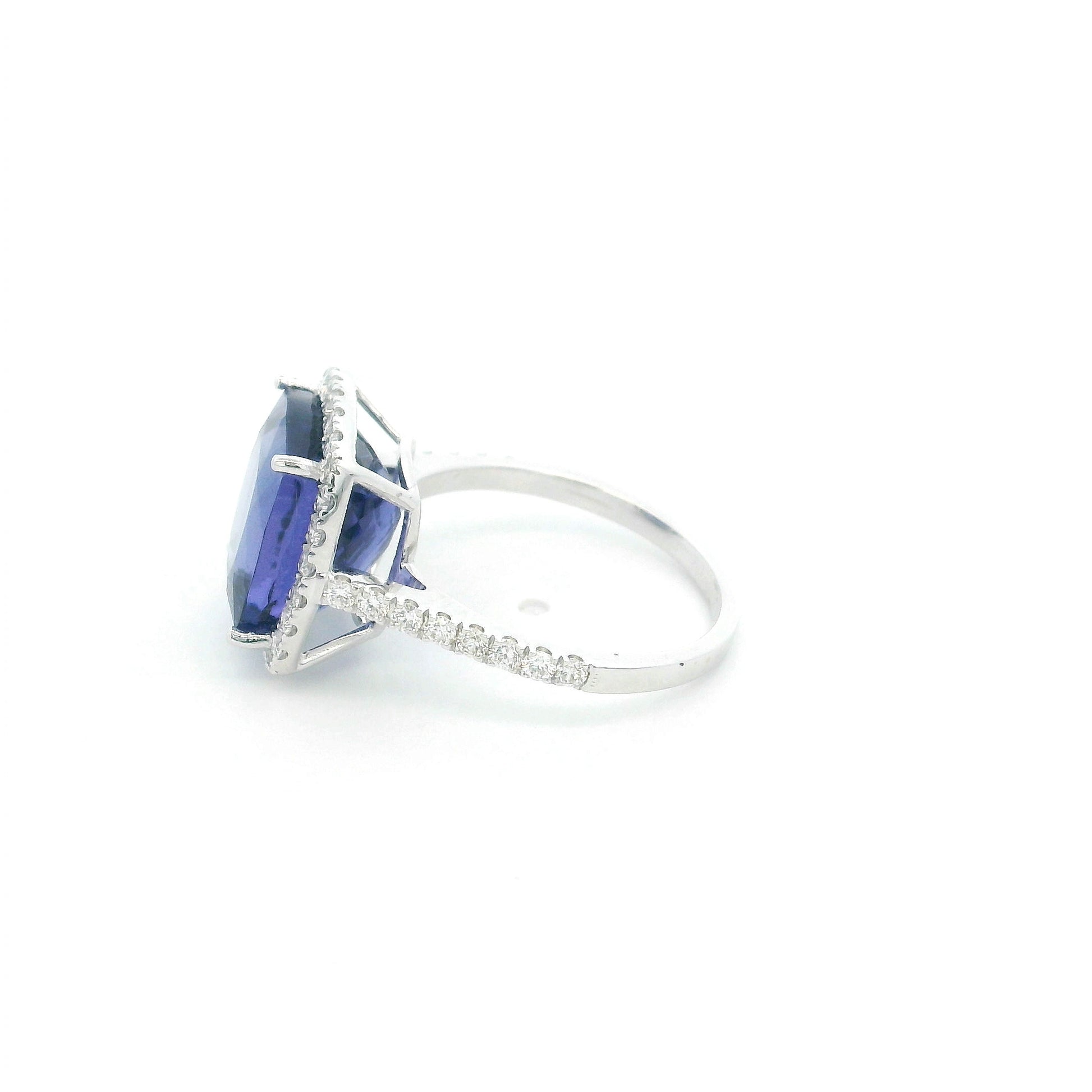 18K white gold cushion cut tanzanite halo ring featuring an 8.95 carat natural tanzanite surrounded by 0.69 carat natural diamonds with diamond-set shoulders.