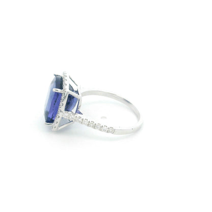 18K white gold cushion cut tanzanite halo ring featuring an 8.95 carat natural tanzanite surrounded by 0.69 carat natural diamonds with diamond-set shoulders.