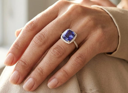 18K white gold cushion cut tanzanite halo ring featuring an 8.95 carat natural tanzanite surrounded by 0.69 carat natural diamonds with diamond-set shoulders.