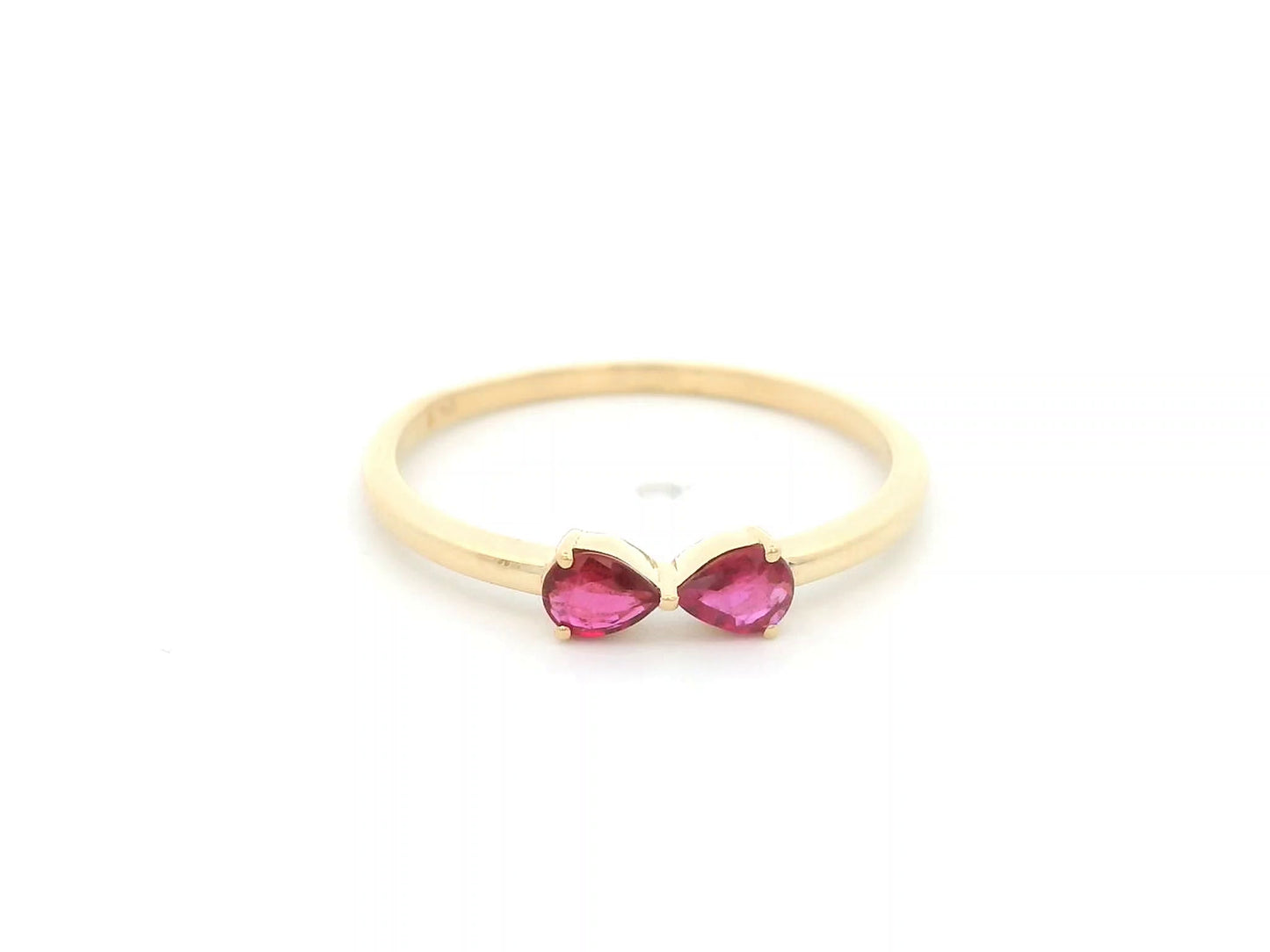 18K yellow gold ruby ring featuring two natural pear-shaped rubies in a delicate ring design.