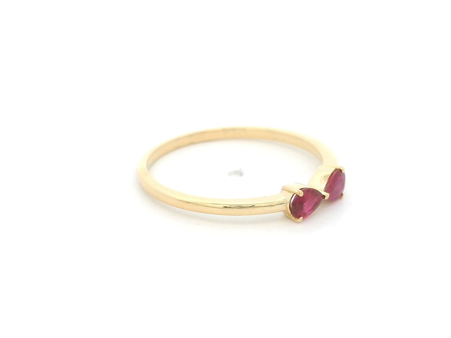 18K yellow gold ruby ring featuring two natural pear-shaped rubies in a delicate ring design.