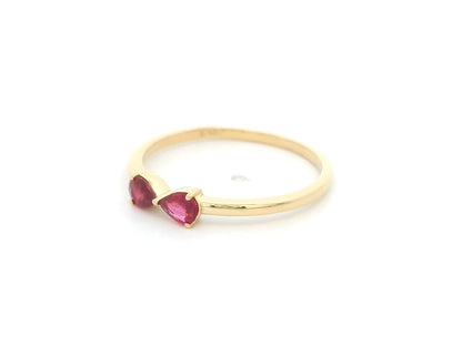 18K yellow gold ruby ring featuring two natural pear-shaped rubies in a delicate ring design.