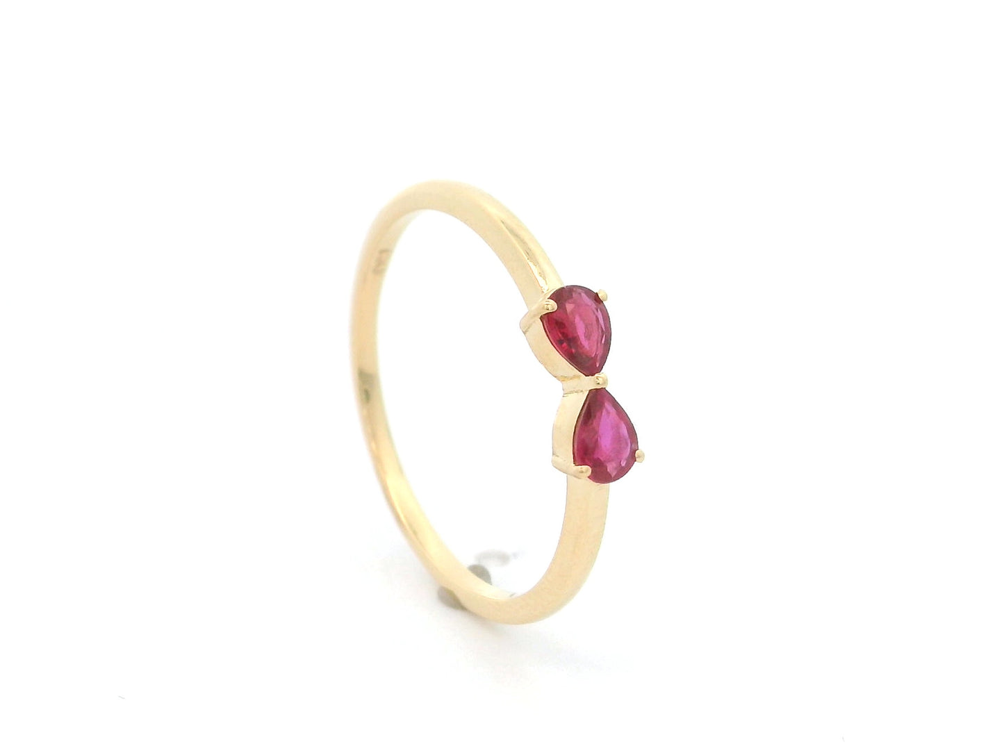 18K yellow gold ruby ring featuring two natural pear-shaped rubies in a delicate ring design.