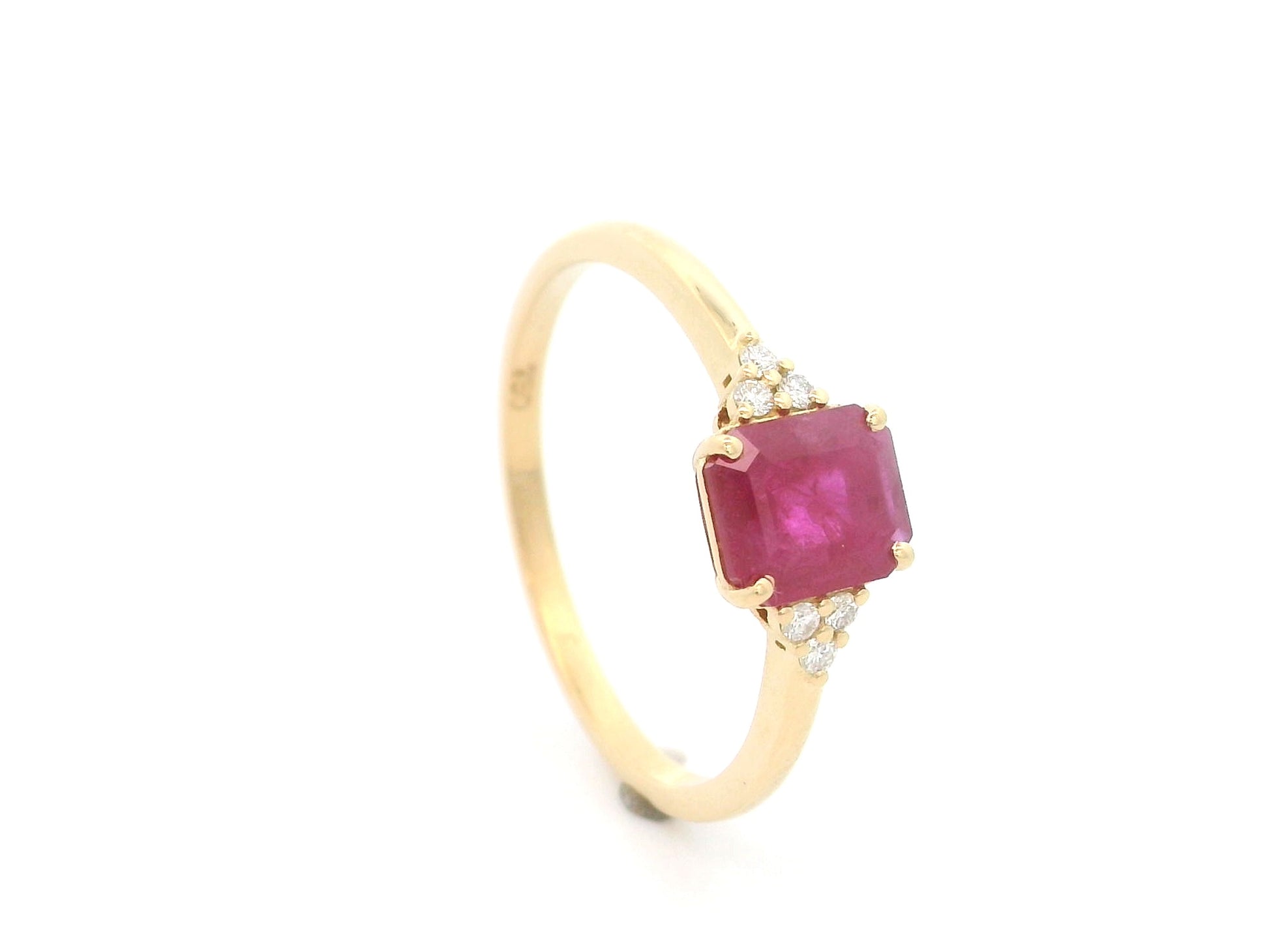 18K yellow gold emerald cut ruby ring featuring a 0.97 Carat natural ruby with sparkling natural diamond side accents.