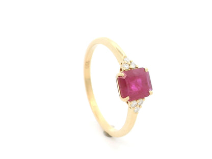 18K yellow gold emerald cut ruby ring featuring a 0.97 Carat natural ruby with sparkling natural diamond side accents.