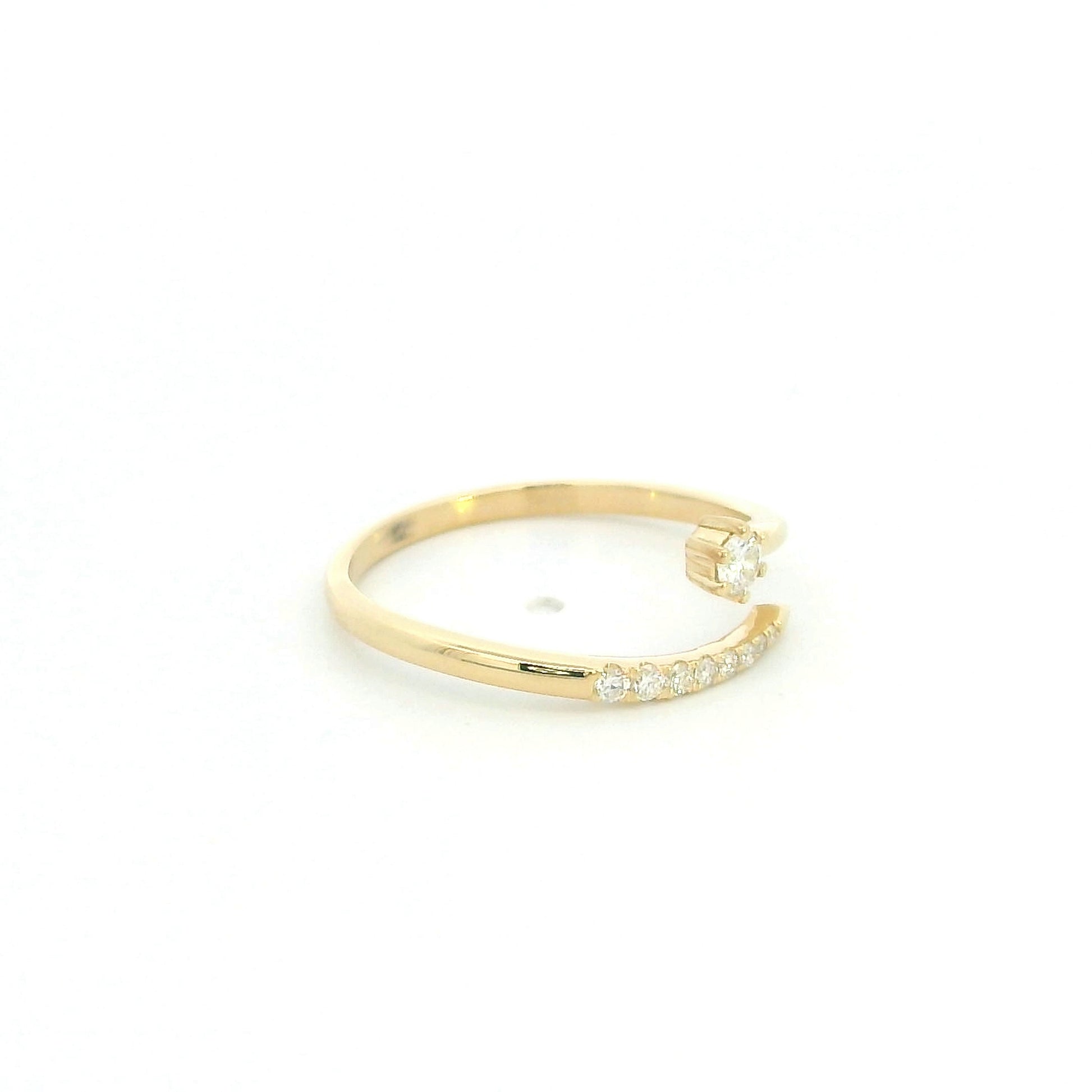 18K yellow gold open diamond ring featuring a round brilliant diamond with a curved row of natural diamonds in a minimalist wrap design.