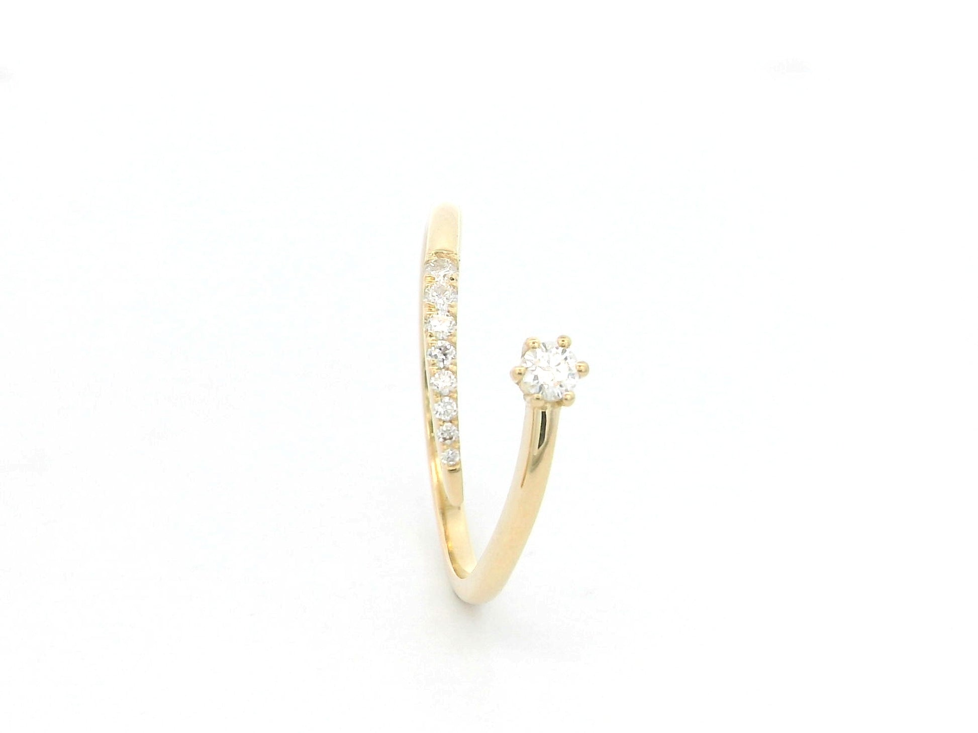 18K yellow gold open diamond ring featuring a round brilliant diamond with a curved row of natural diamonds in a minimalist wrap design.