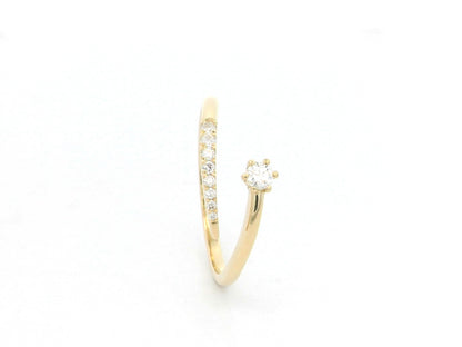 18K yellow gold open diamond ring featuring a round brilliant diamond with a curved row of natural diamonds in a minimalist wrap design.