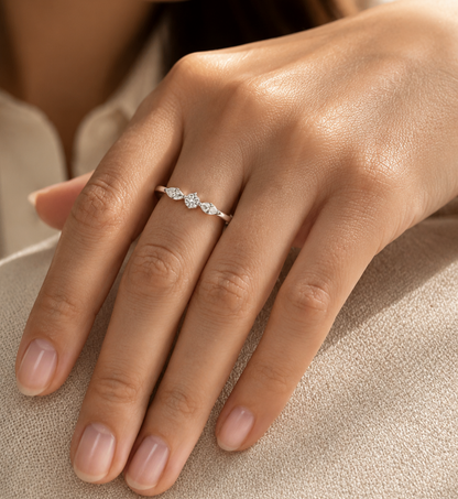 18K white gold three stone diamond ring featuring two marquise-cut diamonds and one round brilliant diamond with a total diamond weight of 0.22 carats.