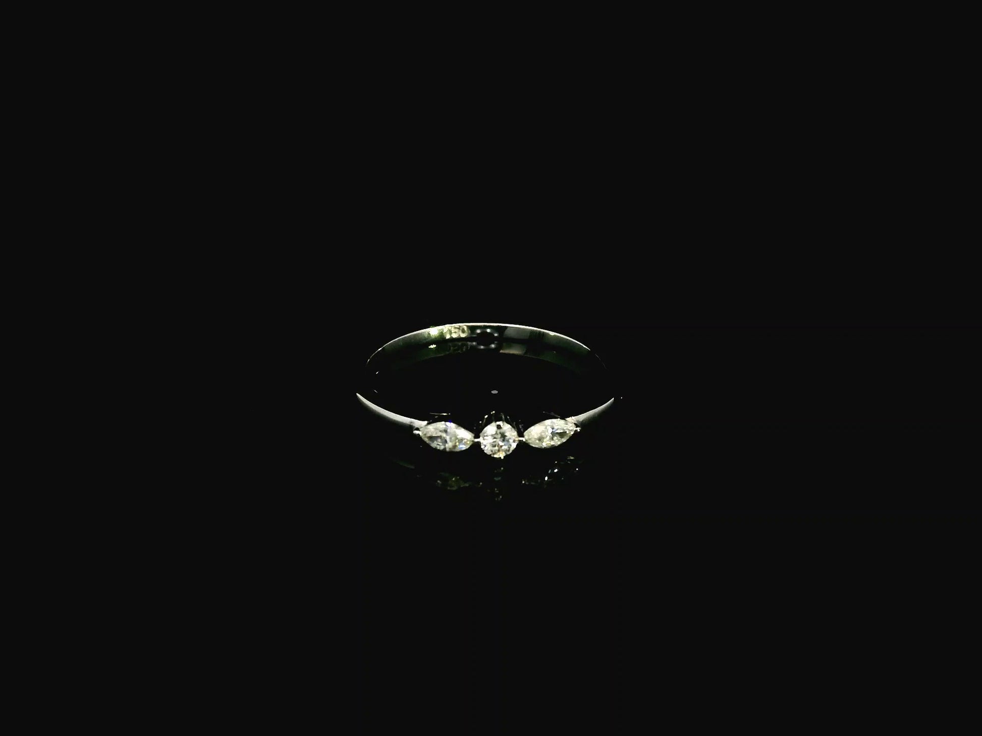 18K white gold three stone diamond ring featuring two marquise-cut diamonds and one round brilliant diamond with a total diamond weight of 0.22 carats.