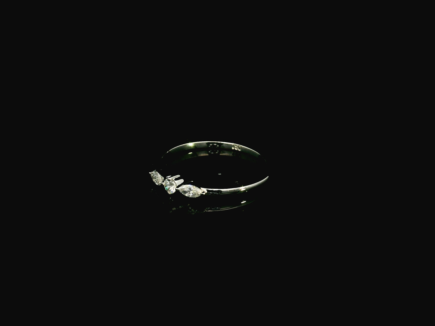 18K white gold three stone diamond ring featuring two marquise-cut diamonds and one round brilliant diamond with a total diamond weight of 0.22 carats.