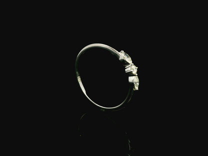 18K white gold three stone diamond ring featuring two marquise-cut diamonds and one round brilliant diamond with a total diamond weight of 0.22 carats.