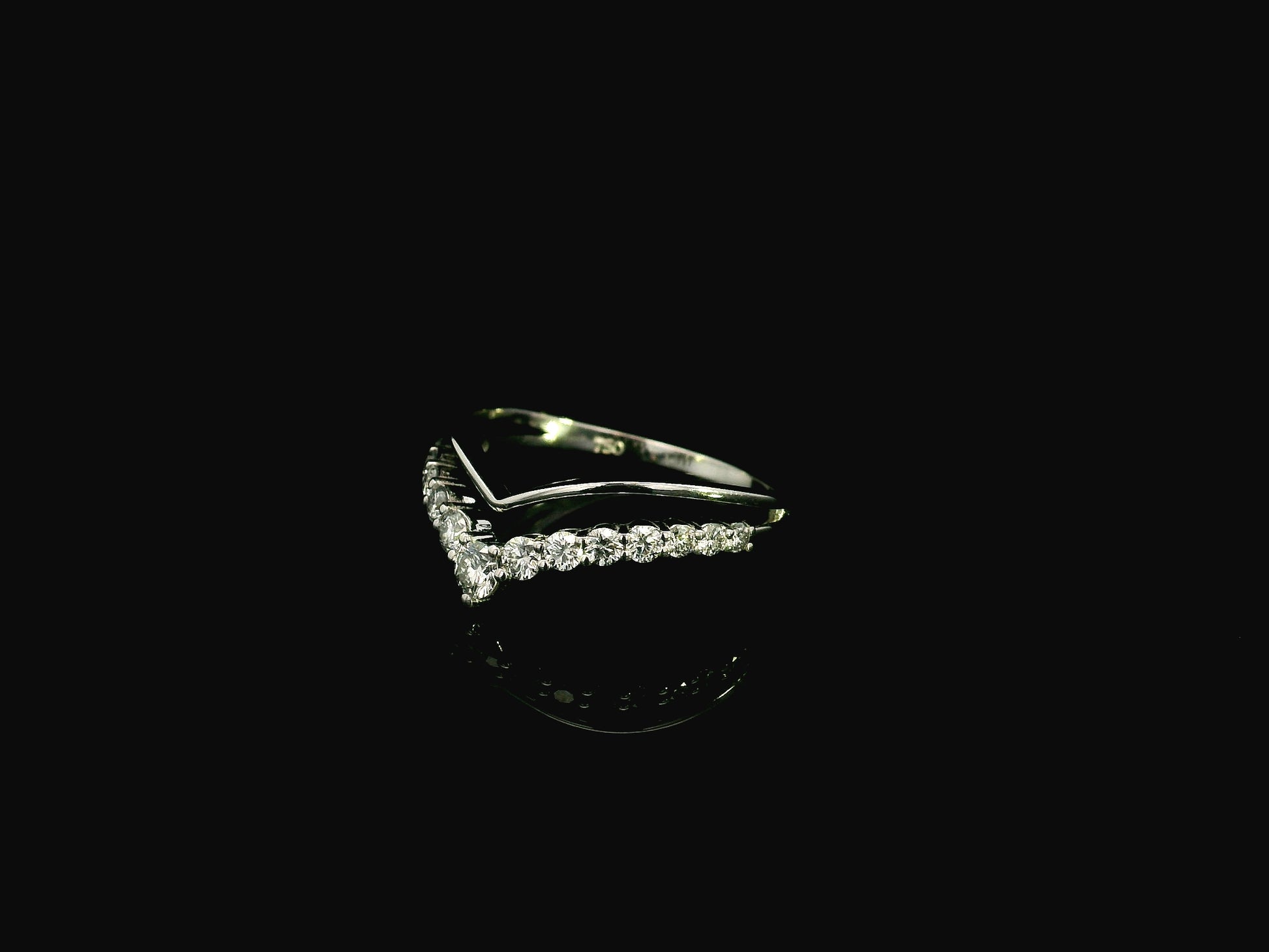 18K white gold graduated chevron diamond ring featuring 0.57 carats of natural diamonds in a V-shaped contour design, perfect as a wedding band, stack ring, or engagement ring enhancer.