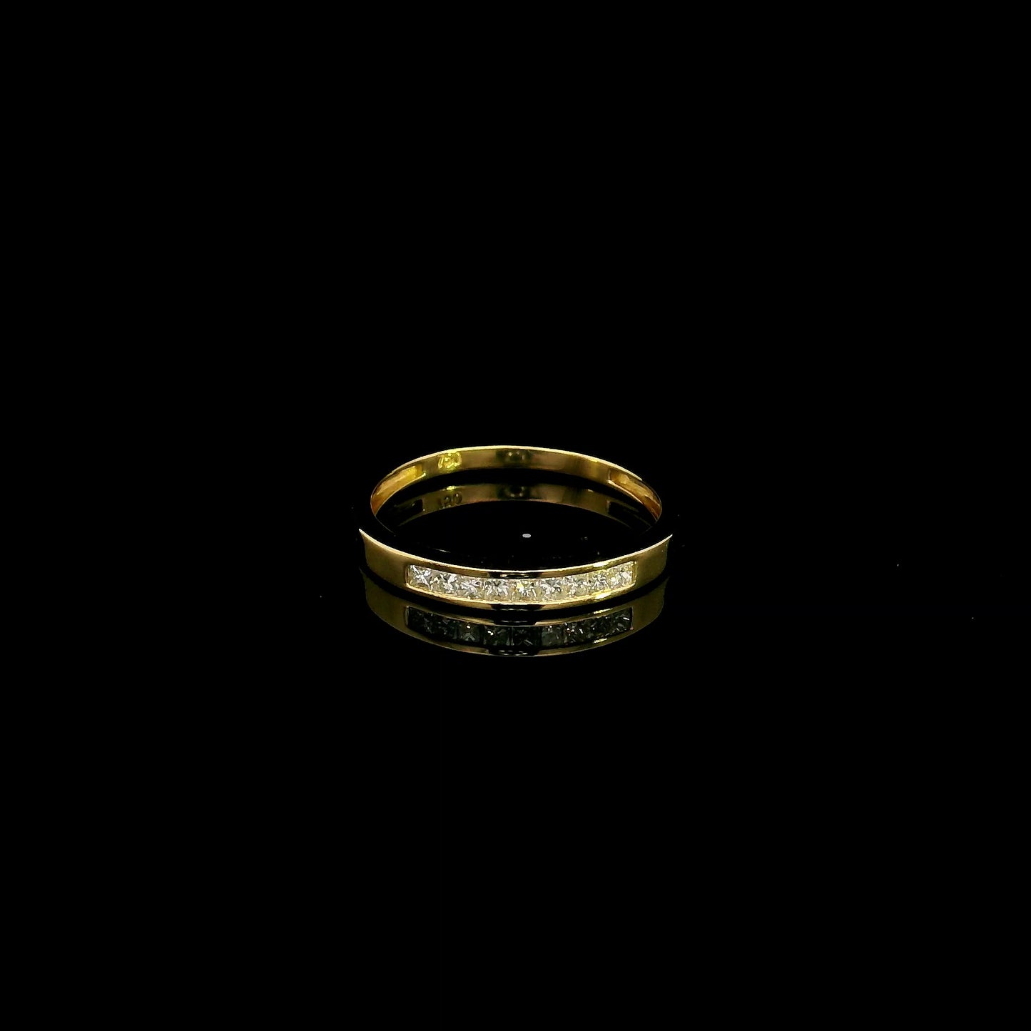 18K yellow gold princess cut diamond ring featuring 0.20 carat natural channel set diamonds in a polished minimalist band.