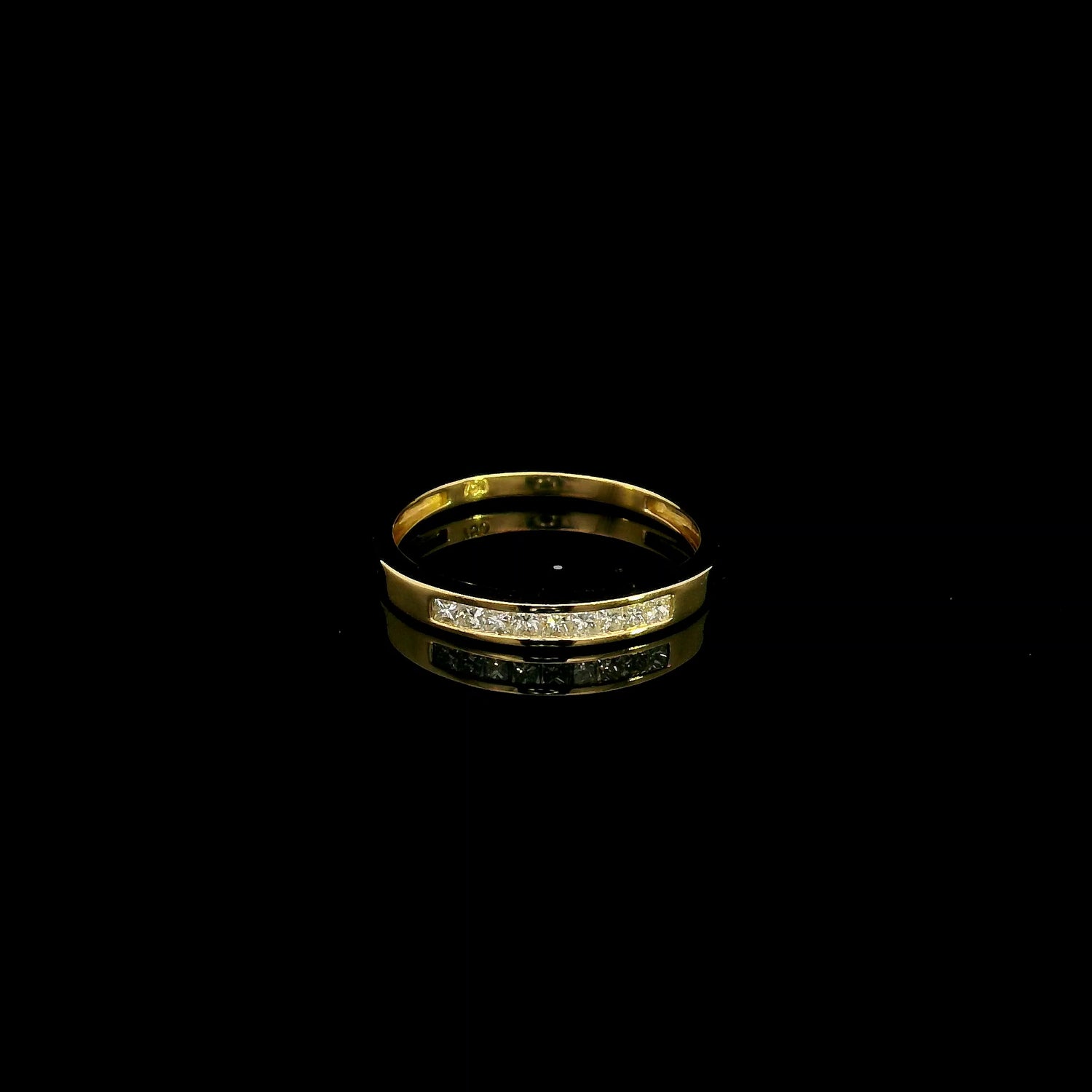 18K yellow gold princess cut diamond ring featuring 0.20 carat natural channel set diamonds in a polished minimalist band.
