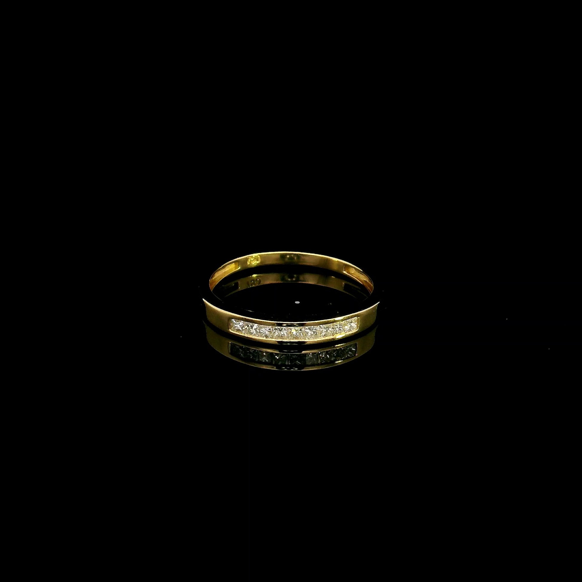 18K yellow gold princess cut diamond ring featuring 0.20 carat natural channel set diamonds in a polished minimalist band.