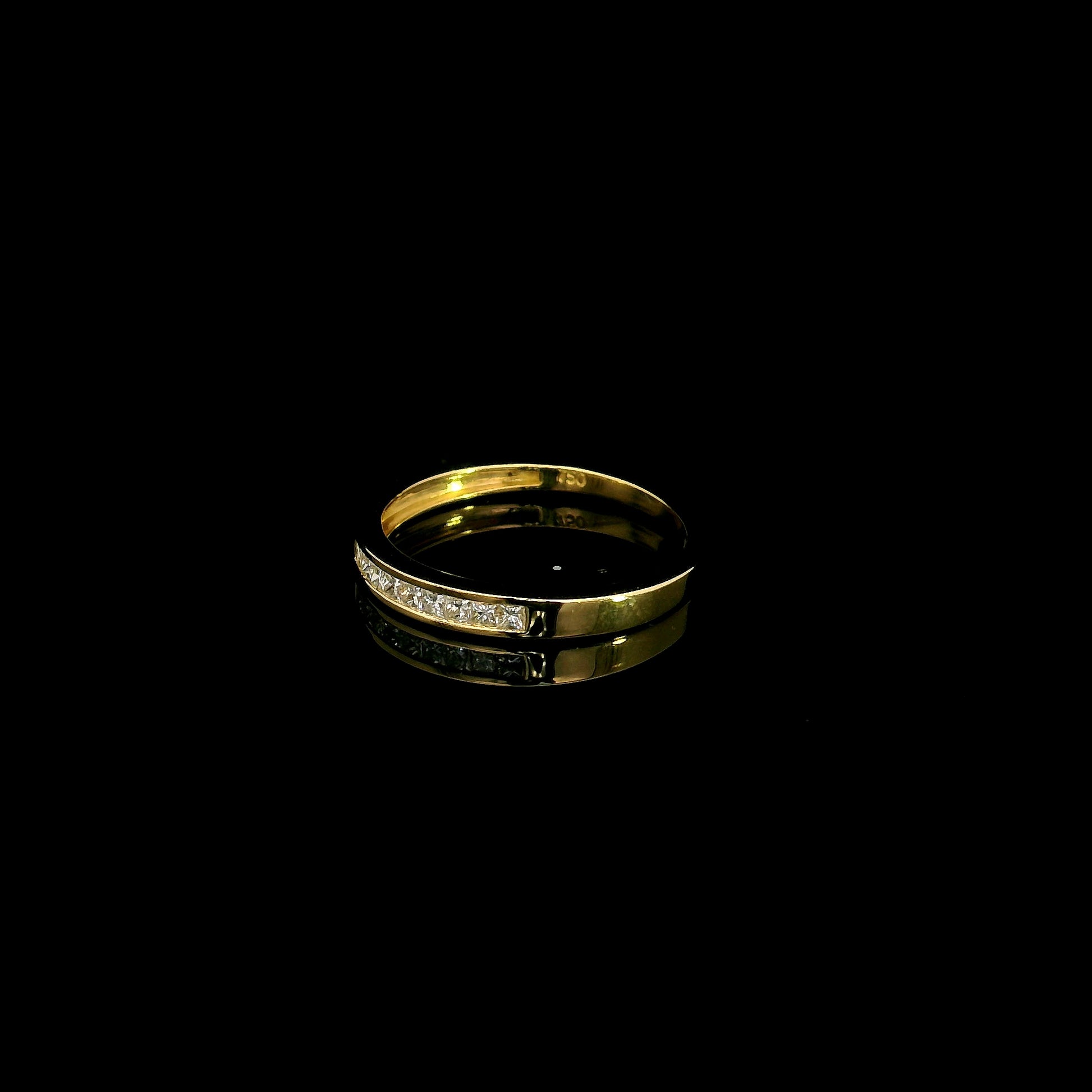 18K yellow gold princess cut diamond ring featuring 0.20 carat natural channel set diamonds in a polished minimalist band.
