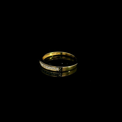 18K yellow gold princess cut diamond ring featuring 0.20 carat natural channel set diamonds in a polished minimalist band.