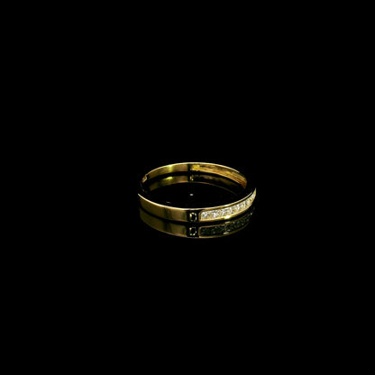 18K yellow gold princess cut diamond ring featuring 0.20 carat natural channel set diamonds in a polished minimalist band.