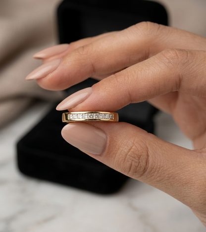 18K yellow gold princess cut diamond ring featuring 0.20 carat natural channel set diamonds in a polished minimalist band.