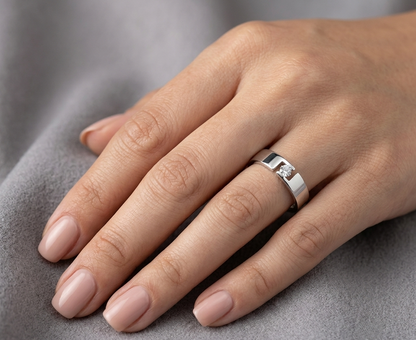 18K white gold floating diamond ring featuring a 0.08 carat natural round brilliant solitaire in a modern open band.